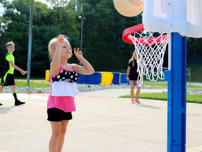 sam-playcare-2 Camper playing basketball